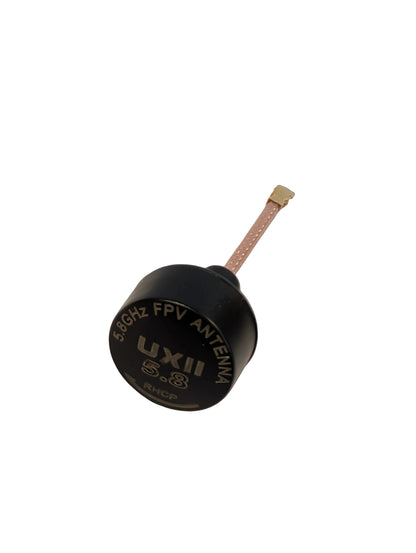 Black UXII 508GHz FPV antenna on a light beige surface