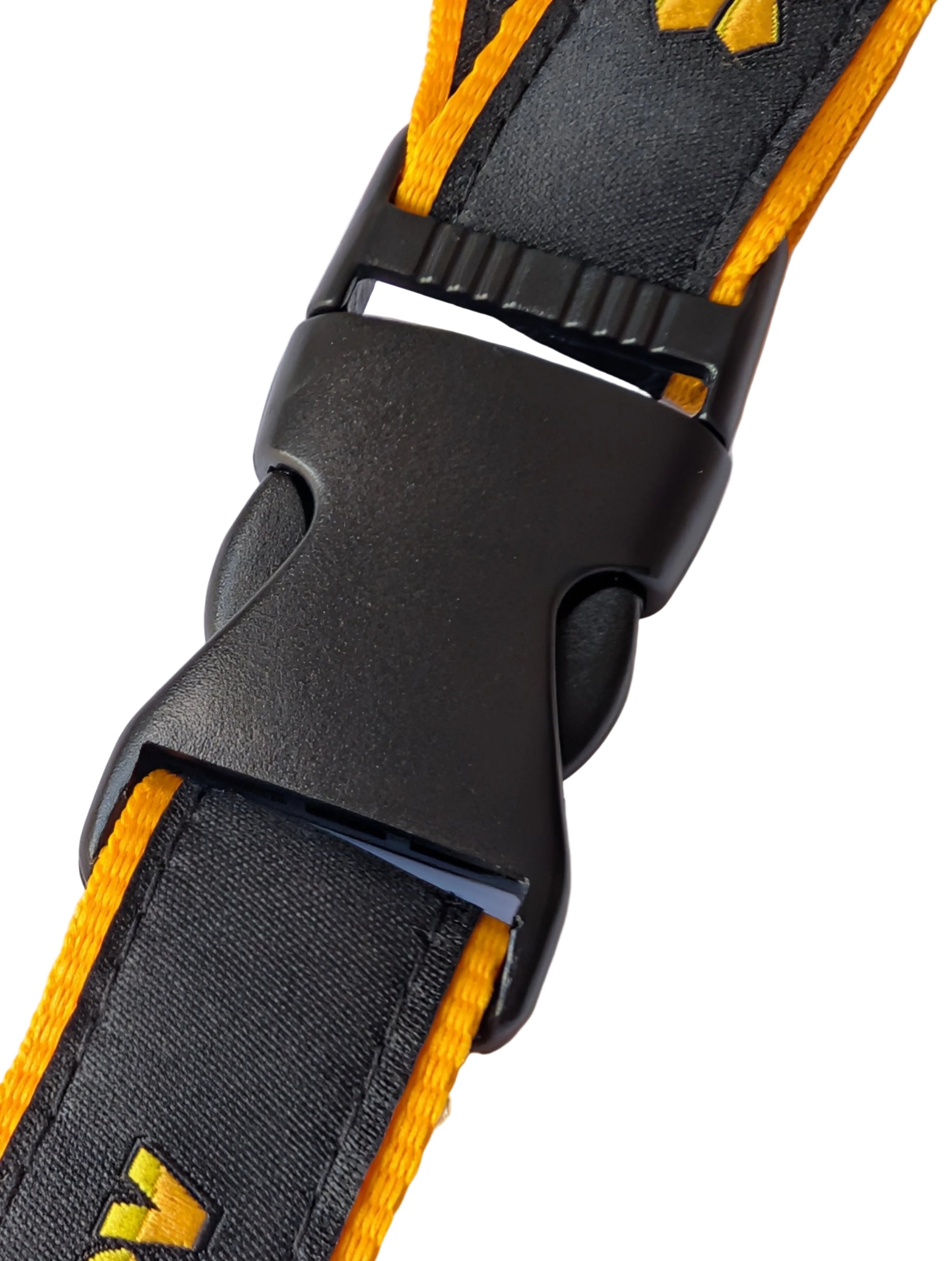 Close-up of a black and yellow strap with a buckle on a white background