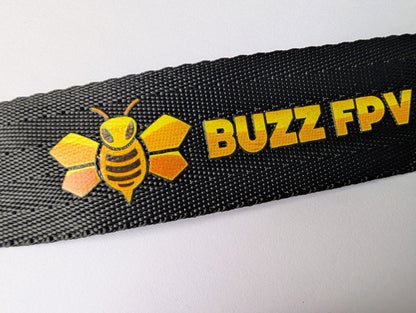 Black strap with Buzz FPV logo featuring a bee design on a white background